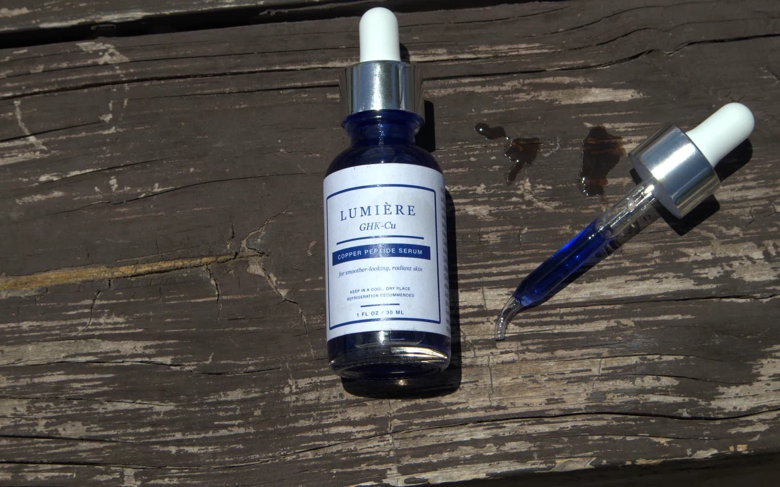 A copper peptide serum dropper photographed in natural light